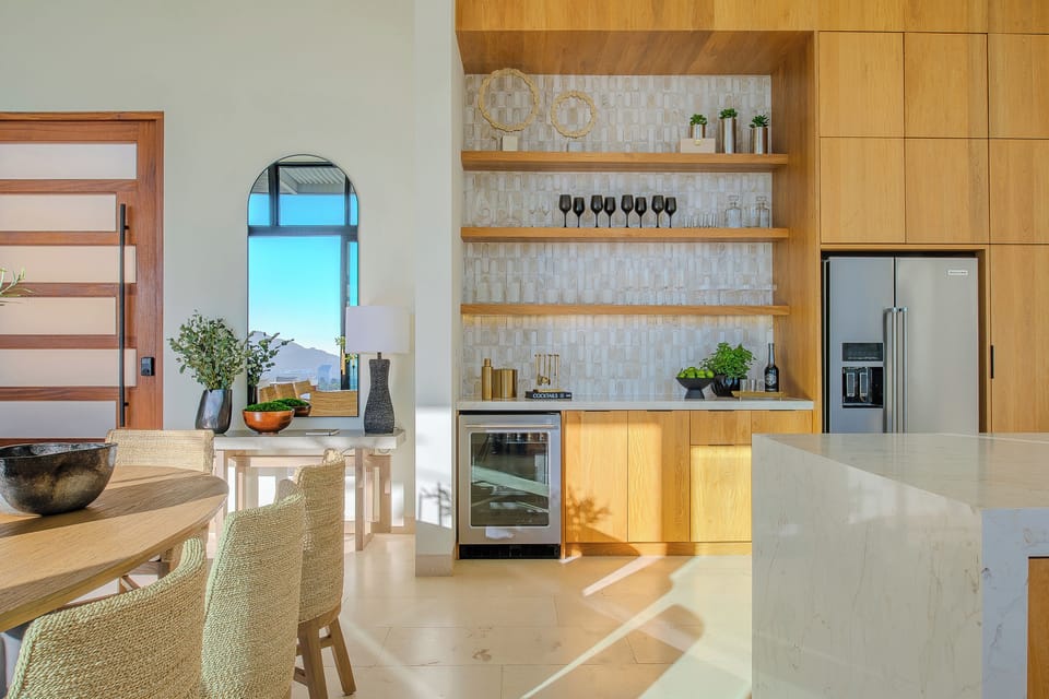 Your gourmet kitchen features warm wood cabinetry, marble countertops, and top-tier appliances for memorable culinary experiences.