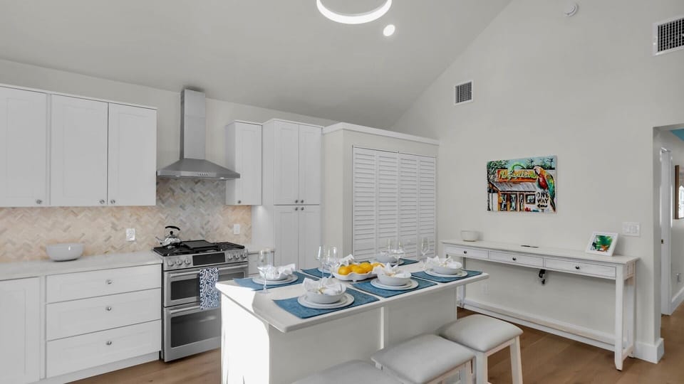 The open kitchen features stainless steel appliances and an eat-in island...