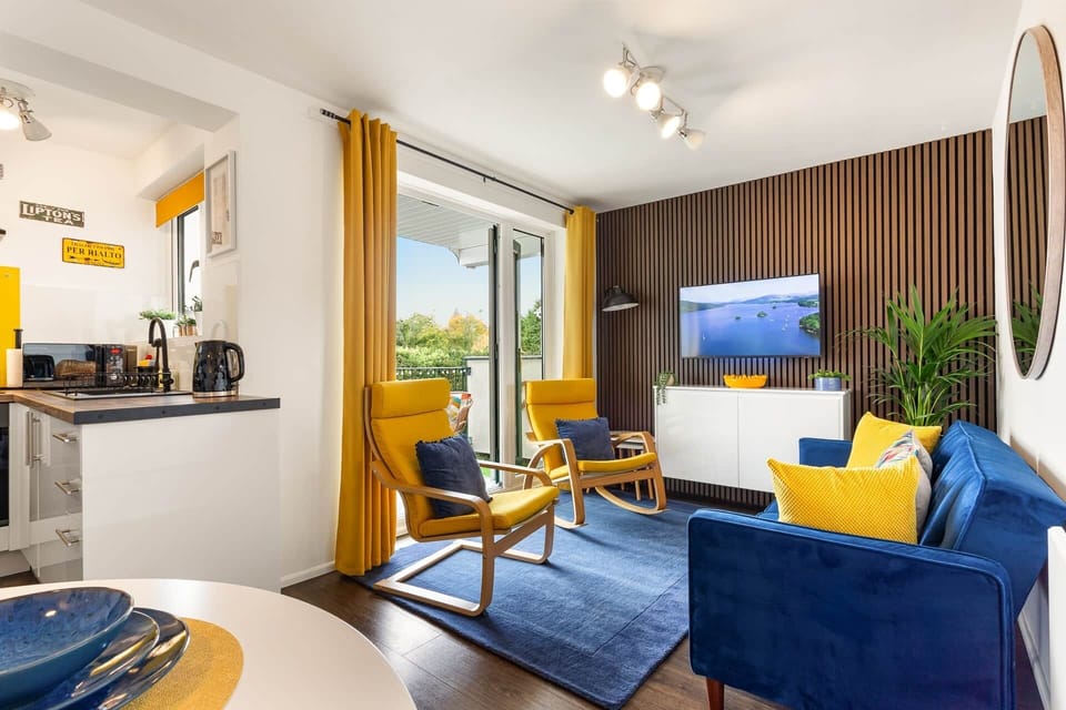 Open plan apartment with lounge, dinning area and kitchen that leads out to the balcony