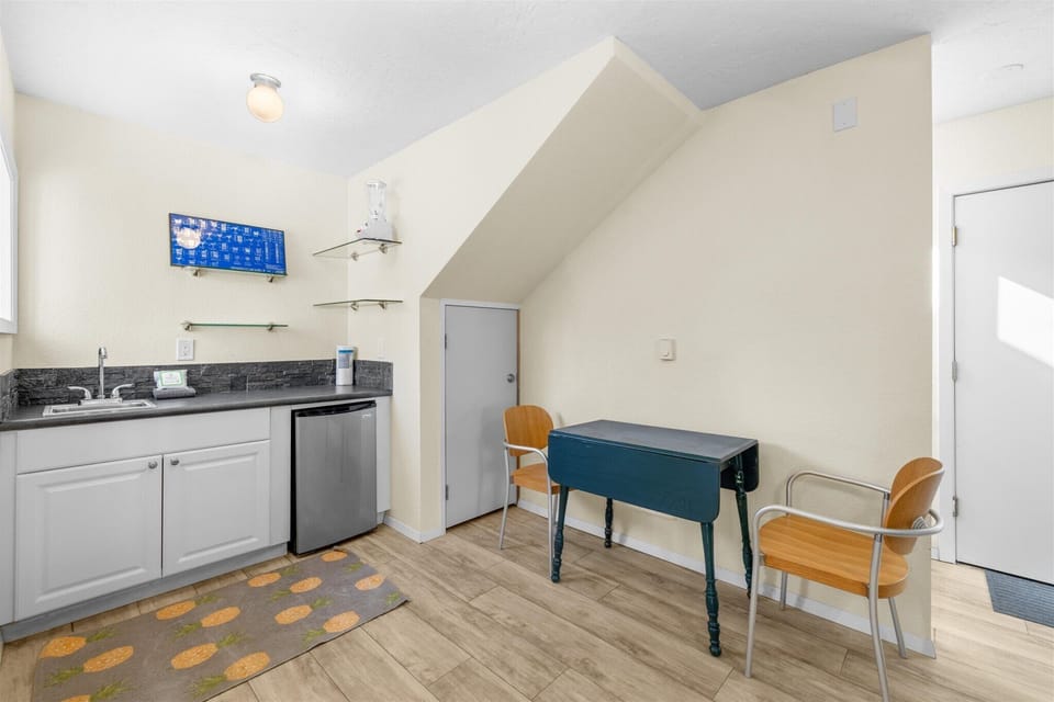 Your charming kitchenette features modern appliances and a cozy dining nook where you can enjoy meals under vaulted ceilings.