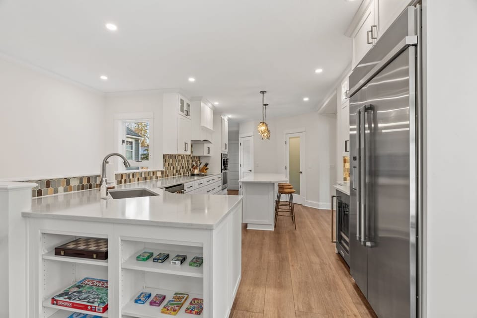 Your gourmet kitchen features gleaming countertops, modern appliances, and a game collection for cozy evenings together.