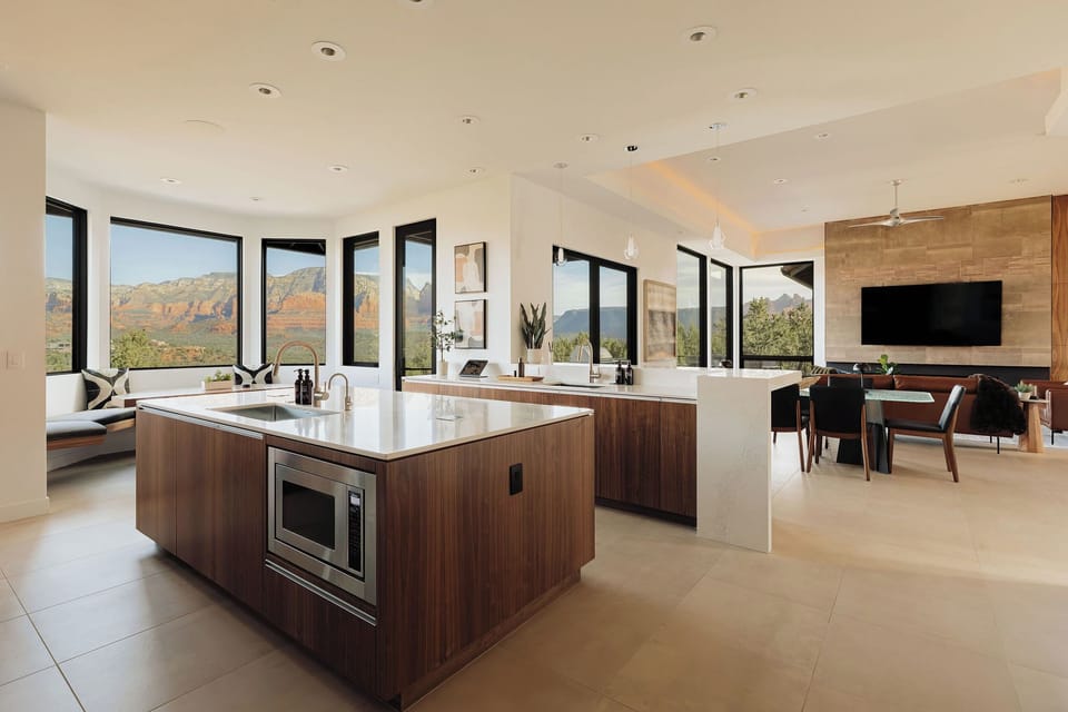You'll love cooking in this stunning open kitchen with sweeping mountain views through floor-to-ceiling windows and premium appliances.
