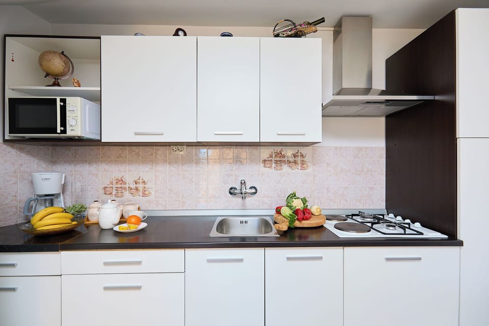 Prepare delicious local meals in the fully equipped kitchen, which features modern appliances and everything you need for a comfortable stay.