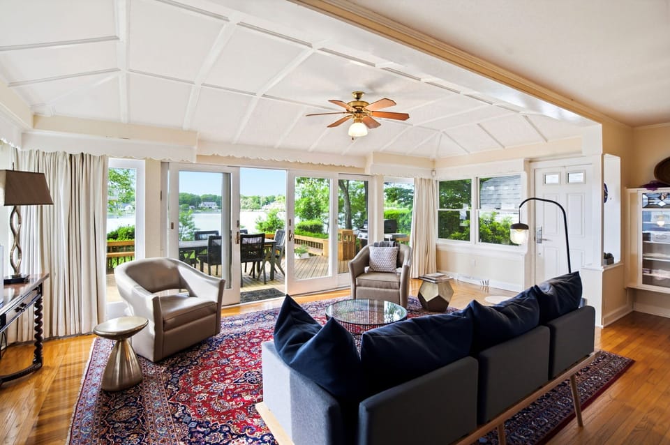 Living room with coffered ceiling and wall of glass to deck