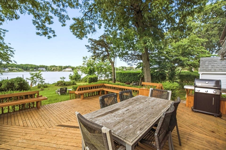 Deck with outdoor dining, grill, and Goose Creek views