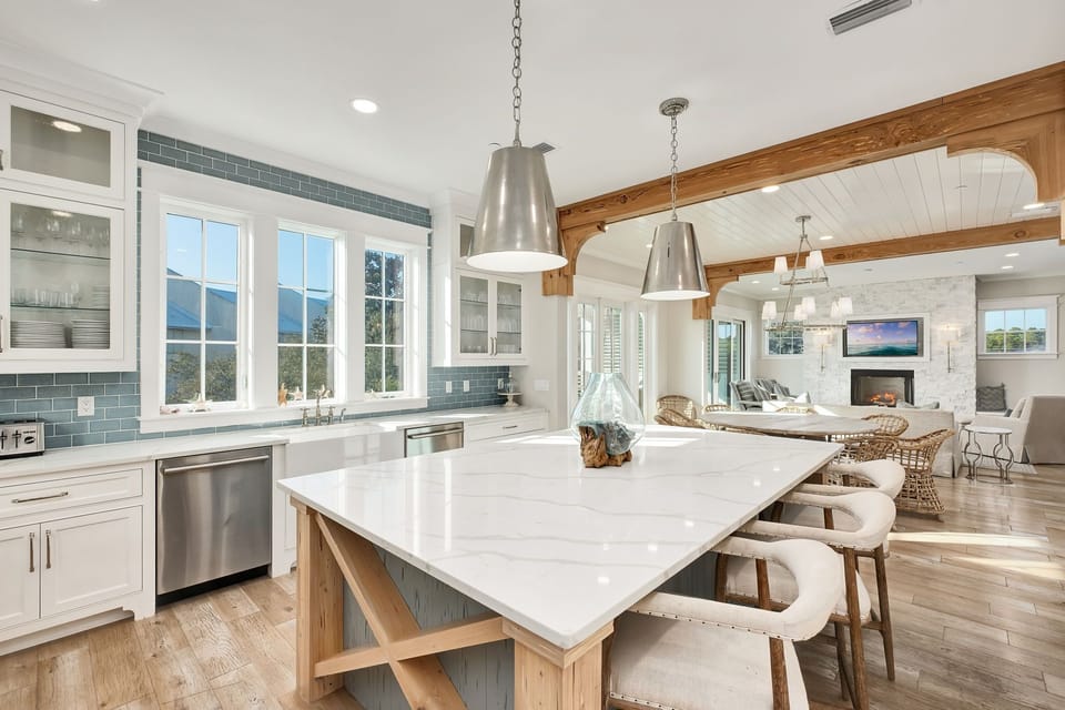 Your dream kitchen awaits with gleaming marble counters, chef-grade appliances, and warm wood beams creating the perfect space for memorable meals.