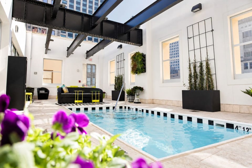 Soak up the airy atrium atmosphere beside the sparkling pool.