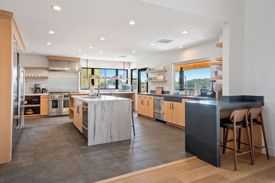 Experience boutique living with a dedicated breakfast bar in this expansive chef's kitchen.