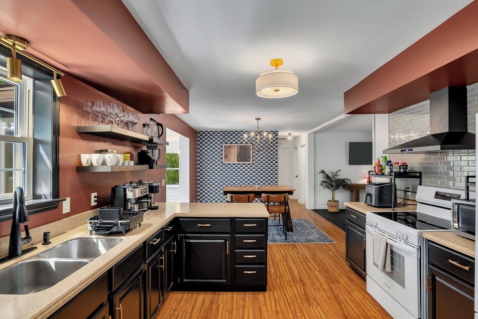 Fully stocked kitchen with cookware, utensils, bakeware, tools and kid plates.