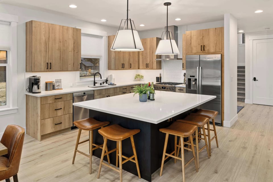Open-concept space connecting the kitchen, dining area, and outdoor patio.