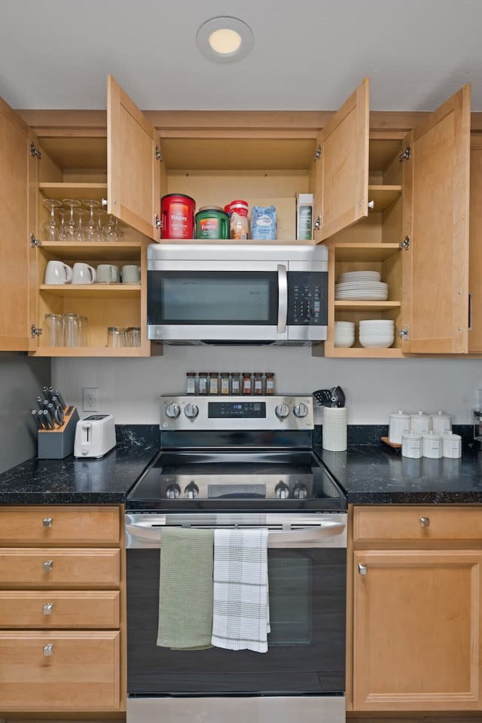 Skip the paper plates and plastic cups... this kitchen is the real deal. Our fully equipped kitchen features plates, dishes, mugs, cups, wine glasses, and a curated spice selection.