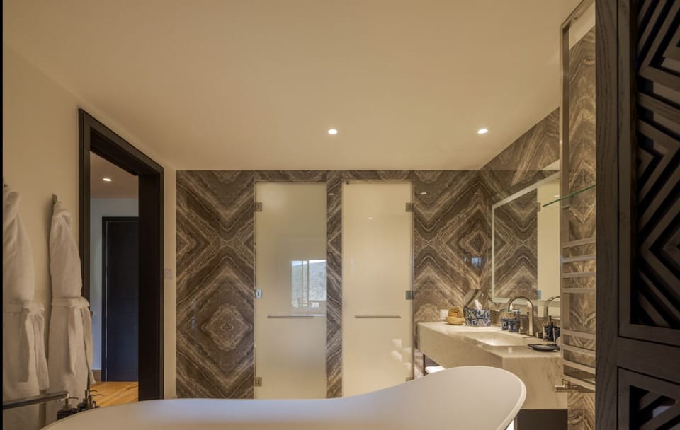 Refresh in a spa-like bath with a sculptural soaking tub.