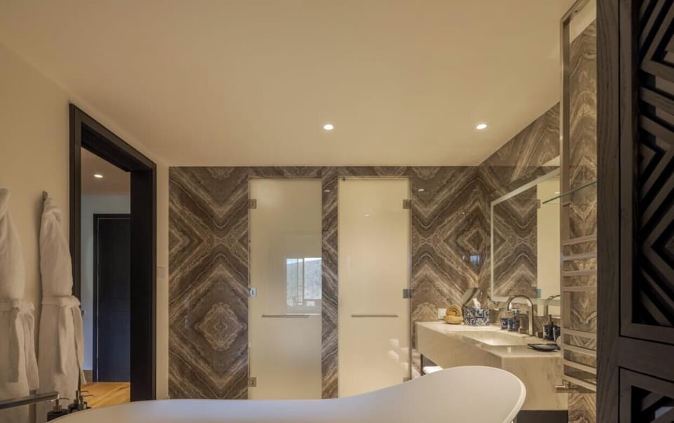 Refresh in a spa-like bath with a sculptural soaking tub.