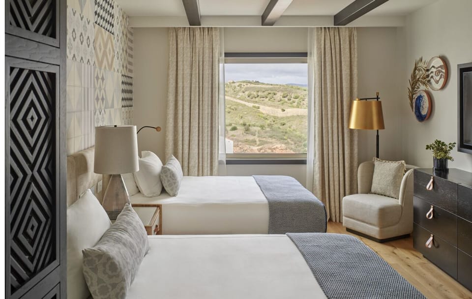 Drift off in crisp linens with calming hillside views.