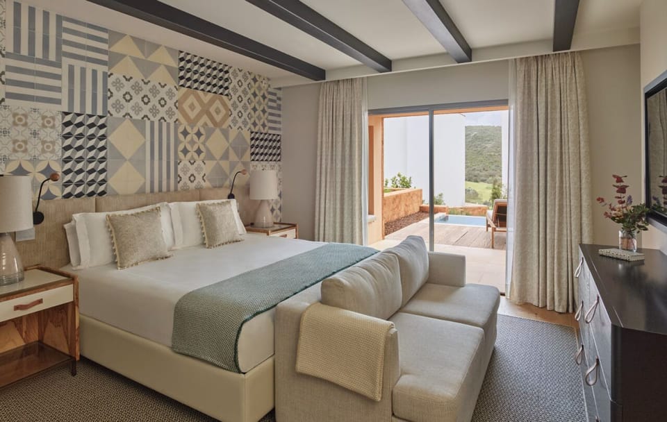 Wake up to sunlit comfort with terrace views beyond.