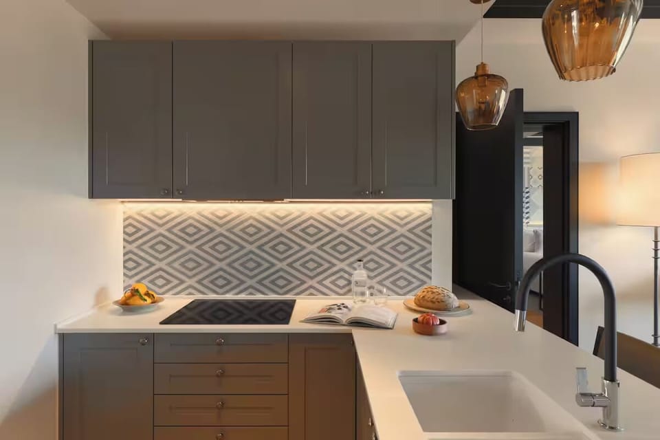 Prep fresh meals on sleek counters under warm pendant glow.