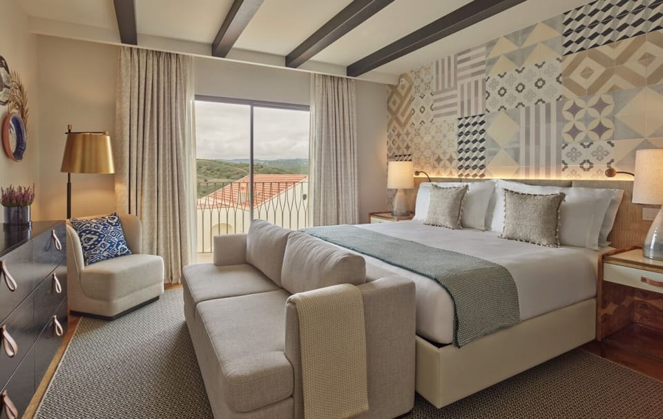 Unwind in a serene king suite with panoramic balcony views.