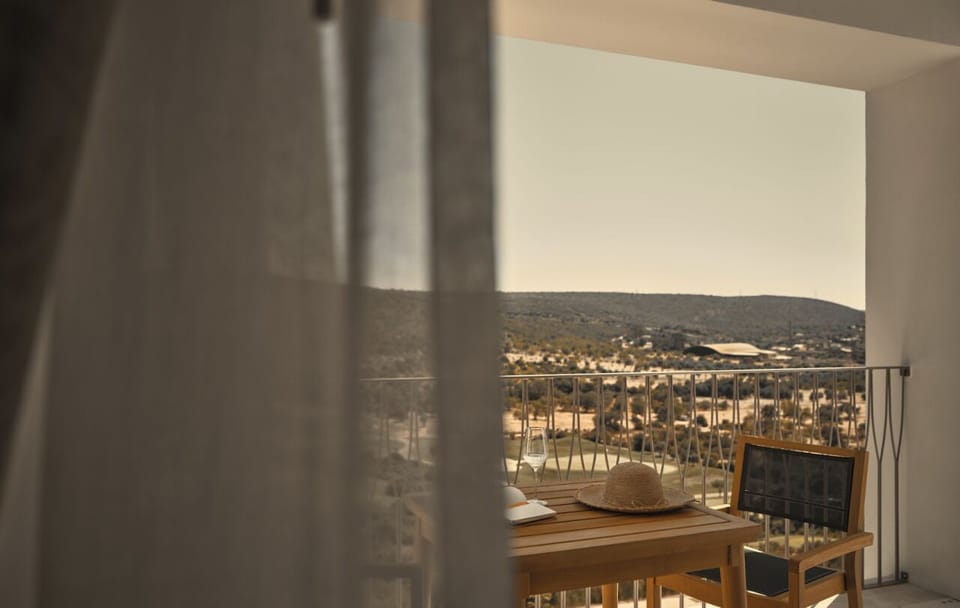 Sip morning coffee on the balcony overlooking rolling green hills.