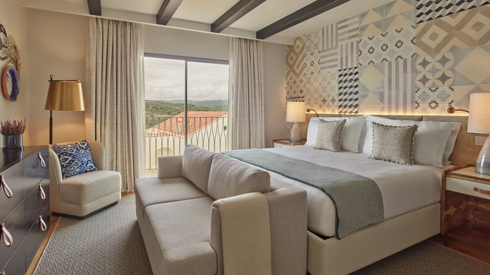 Unwind in a sunlit suite with plush king bed.
