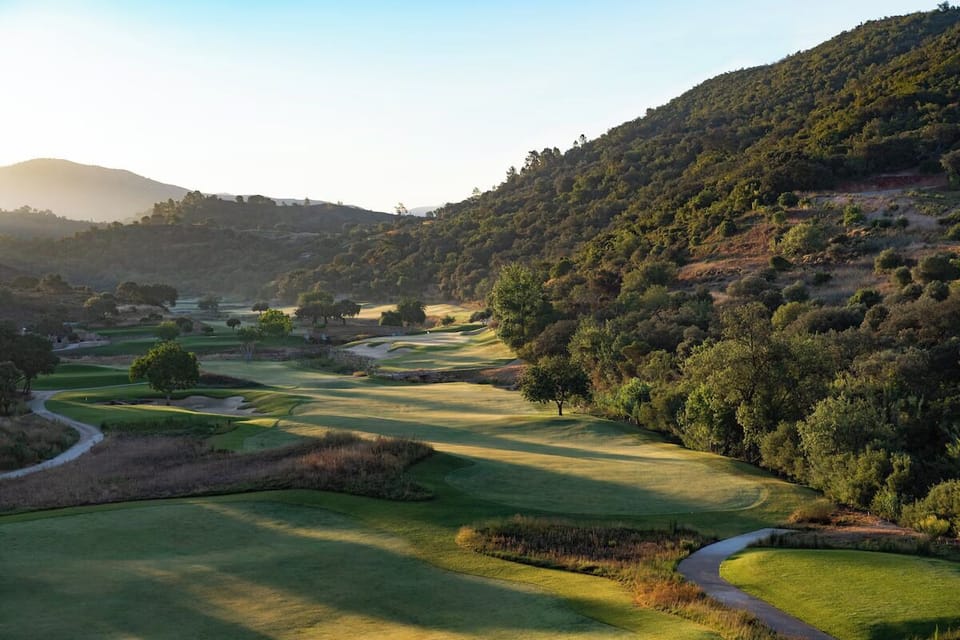 Wander along sunlit fairways framed by serene hillsides.