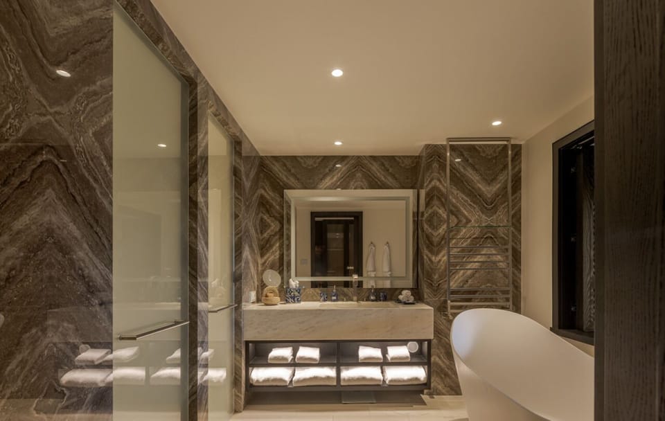 Indulge in spa-style pampering with double vanity and luxe stone.
