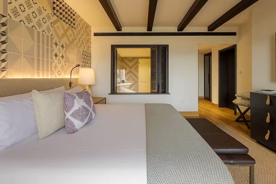 Wake slowly under rustic beams in a calm, airy retreat.