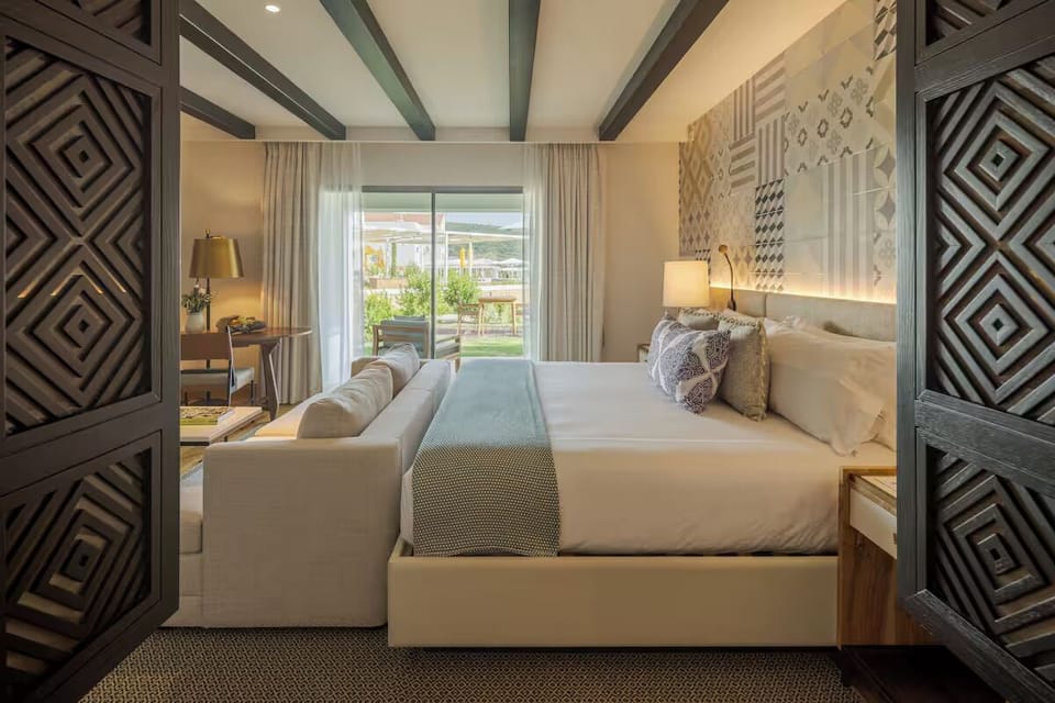 Relax in a spacious suite with cozy seating and soft linens.