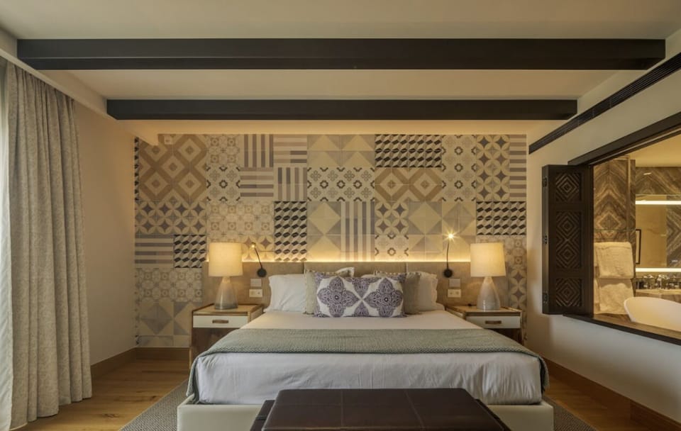 Drift into deep sleep beneath statement lighting and soft linens