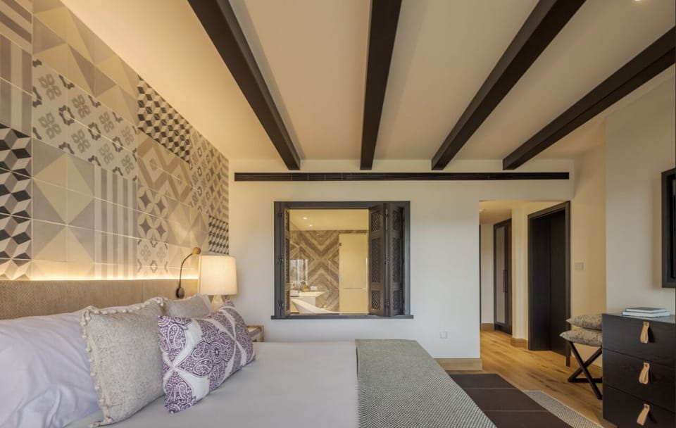 Linger in bed as daylight pours through wide glass doors.