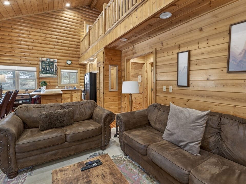 Living Room | Timber Ceilings, Stone Fireplace & Open Dining Space