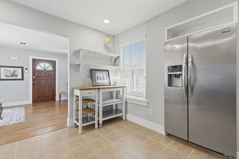 Clean utility space with a refrigerator, perfect for keeping drinks and snacks fresh during your stay.