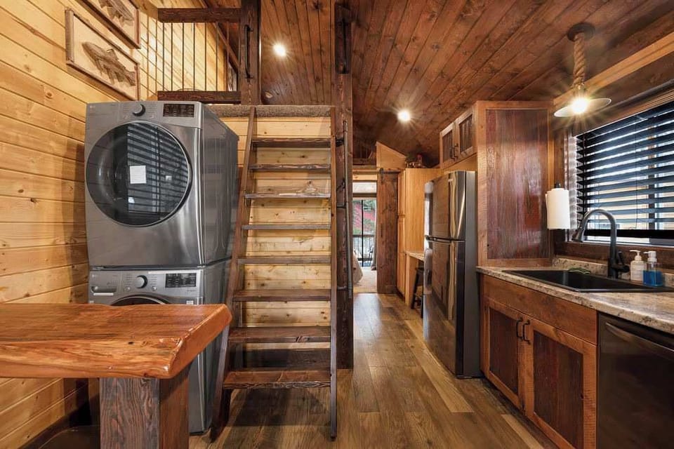 Kitchen with laundry area and ladder for the climb up loft.