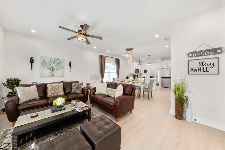 Your group will love gathering in this bright, airy living space. Comfortable seating for everyone with natural light pouring through the windows and an open flow to the dining area.