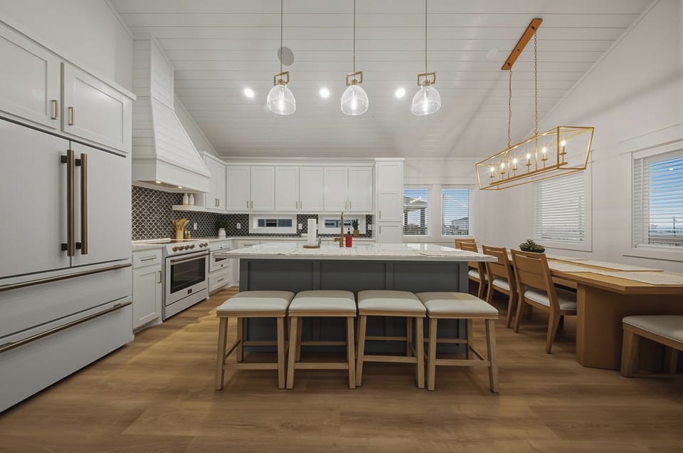 A chef-worthy coastal kitchen—spacious island seating, modern appliances, and a bright dining nook for easy family meals.