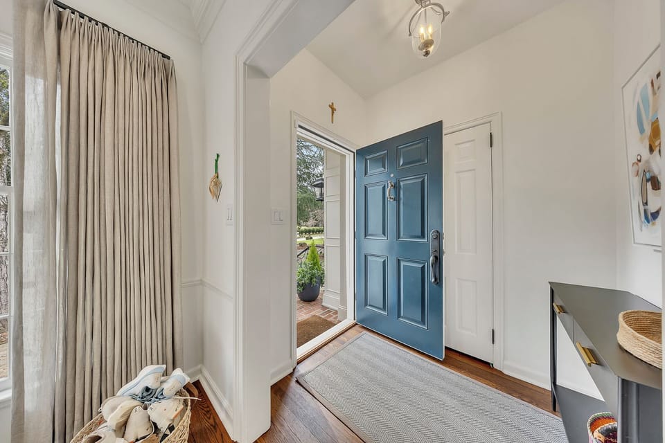 Welcoming front entry with a bold blue door