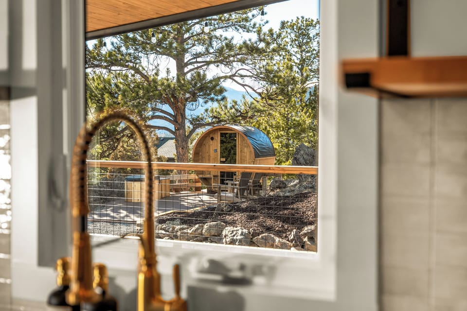 The Barrel Sauna and cold plunge are nestled into the rock formation  - with a view from the house. 