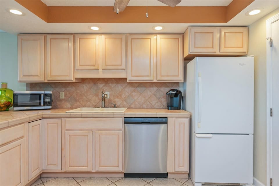 Prepare your favorite meals in this fully-equipped kitchen featuring modern appliances and ample cabinet space for all your culinary adventures.