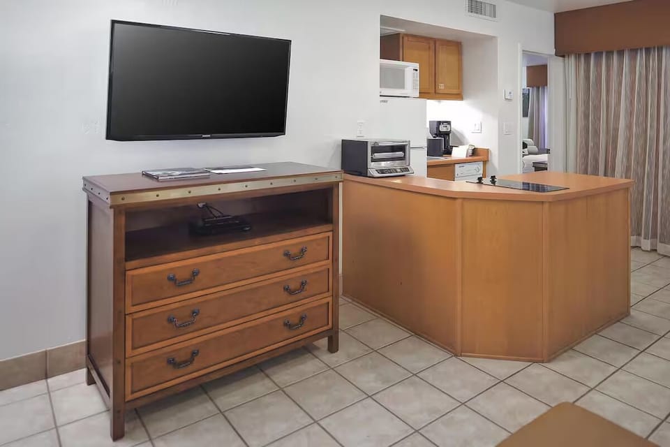Settle in with entertainment and handy kitchenette essentials nearby