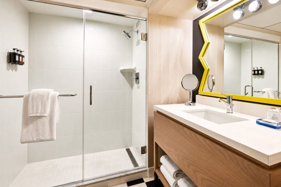 Rinse off in a sleek glass shower and bright vanity.
