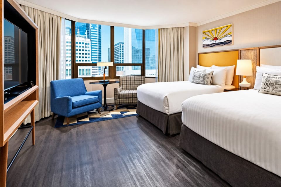 Wake up to skyline views from a spacious, sunlit room.