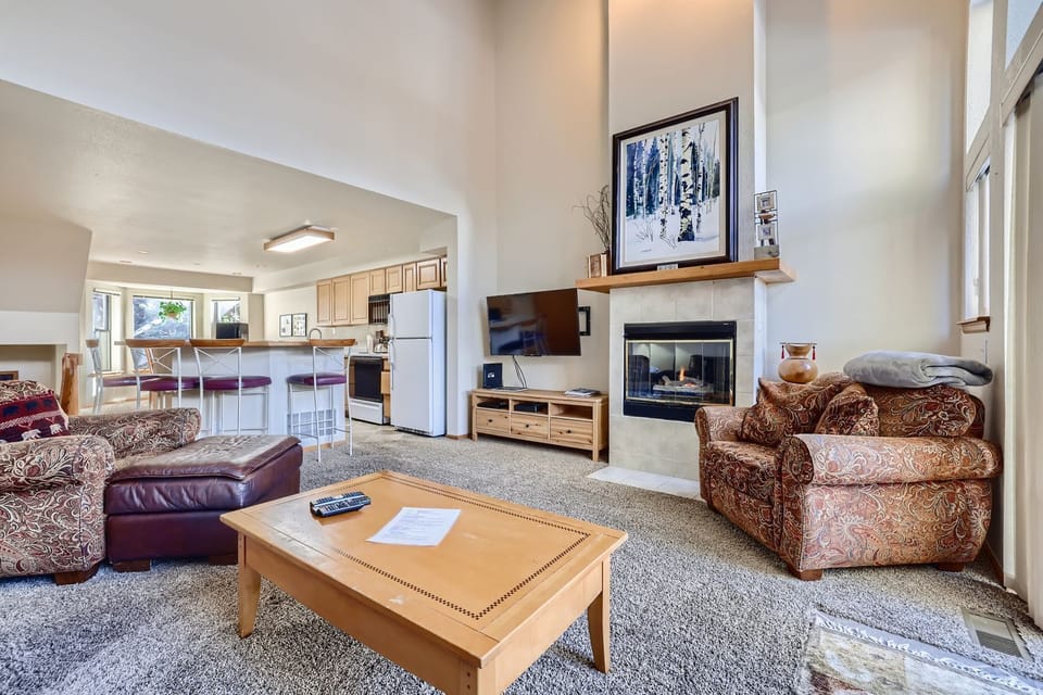 Relax in your spacious living room with cozy fireplace and open kitchen—perfect for unwinding after mountain adventures.