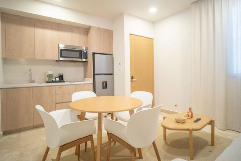 Cook and snack easily with a sleek kitchenette and dining table.