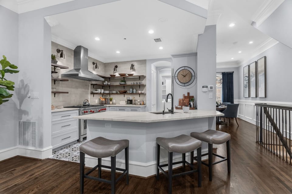 Gourmet kitchen featuring a spacious breakfast bar and professional appliances.
