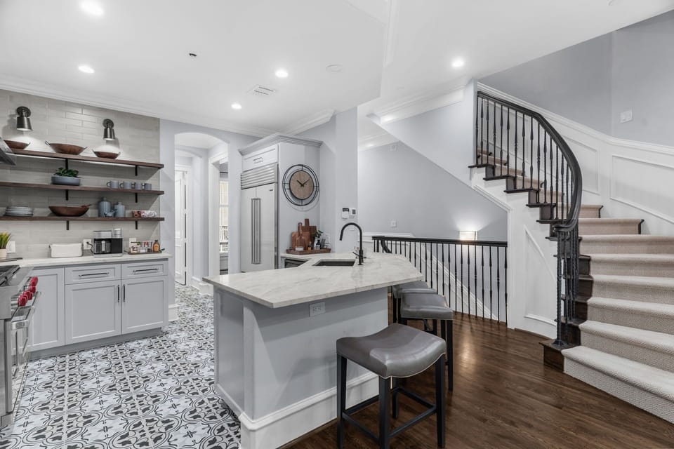 Gourmet kitchen featuring a spacious breakfast bar and professional appliances.
