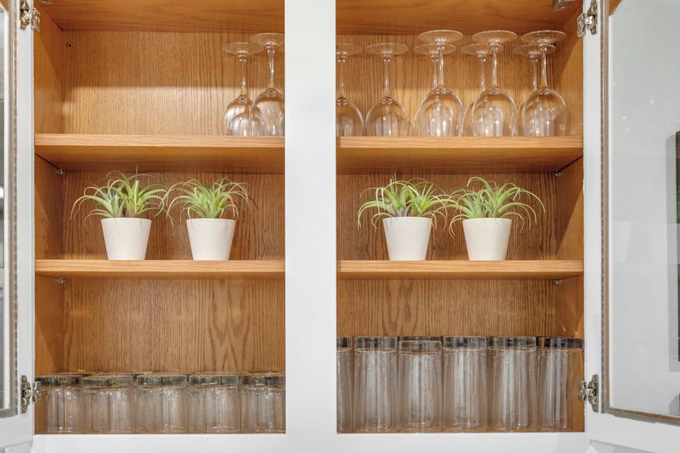 Kitchen cabinets stocked with glassware and essentials to make your stay convenient and comfortable.