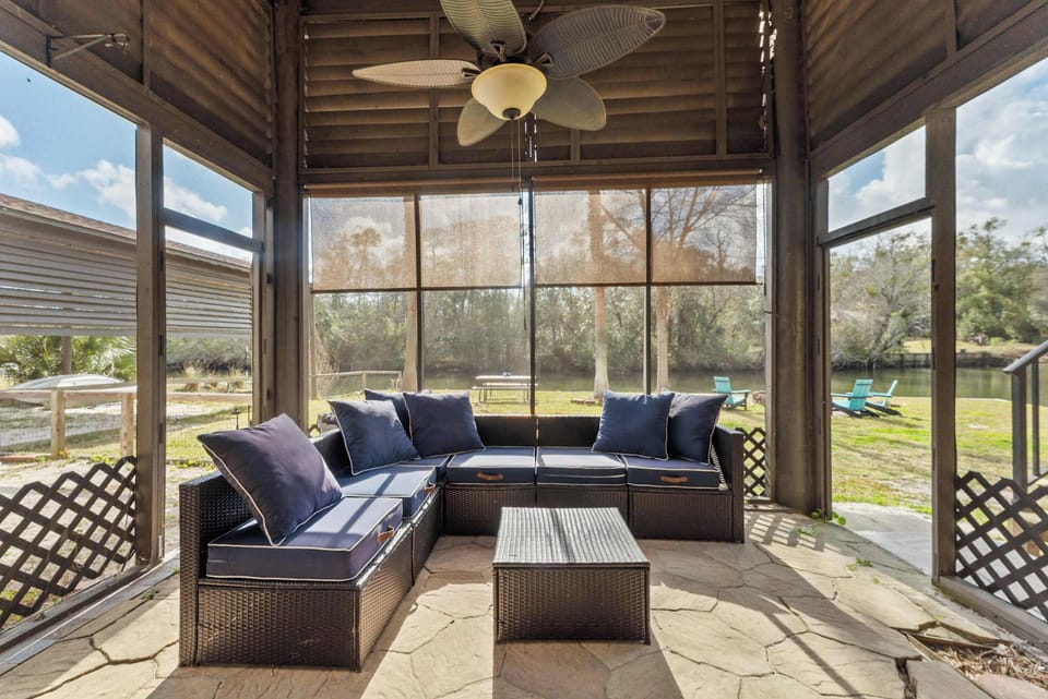 Private screened patio seating area overlooking the peaceful riverfront