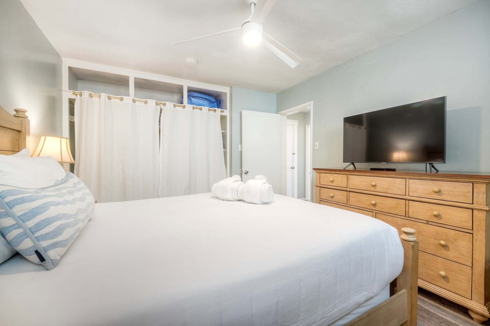 Spacious bedroom with TV and plush bed