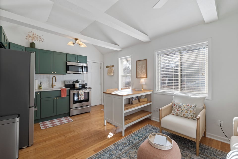 Open living area with full kitchen, island, and plenty of natural light.