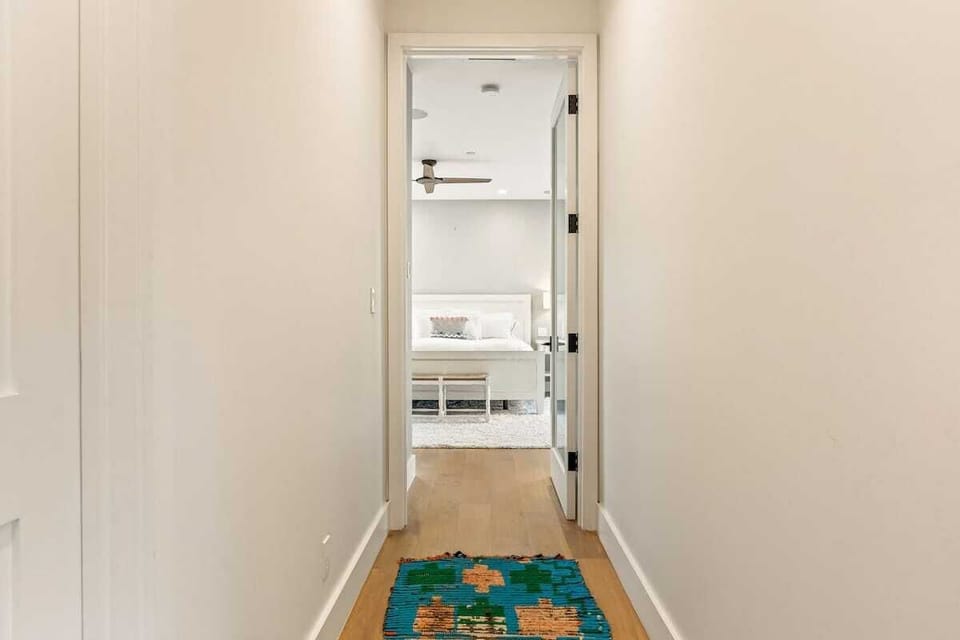 Hallway leading to the primary bedroom, creating a quiet and private retreat within the home.