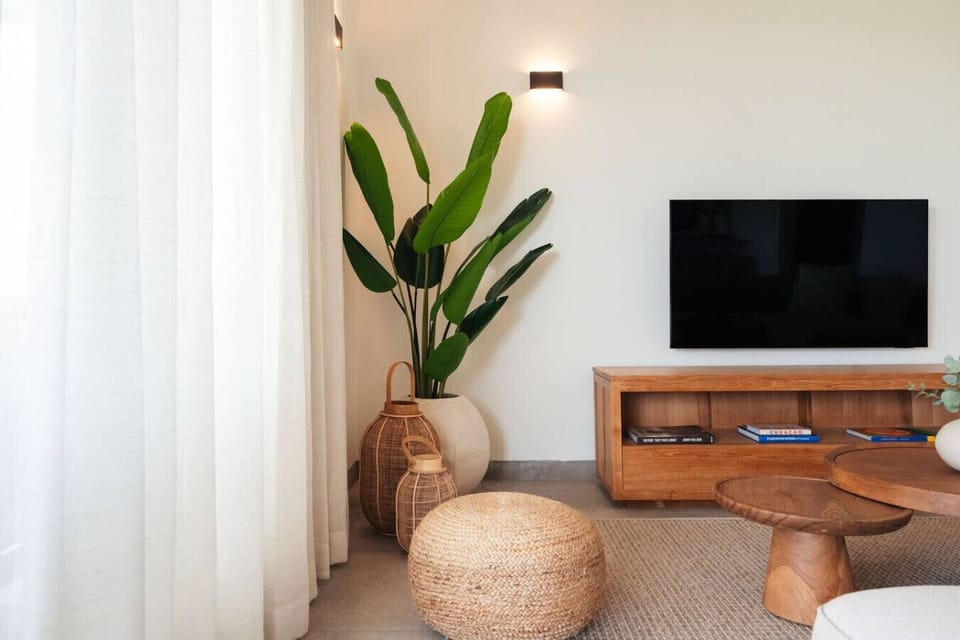 A cozy corner of the living room with comfortable seating and a TV.